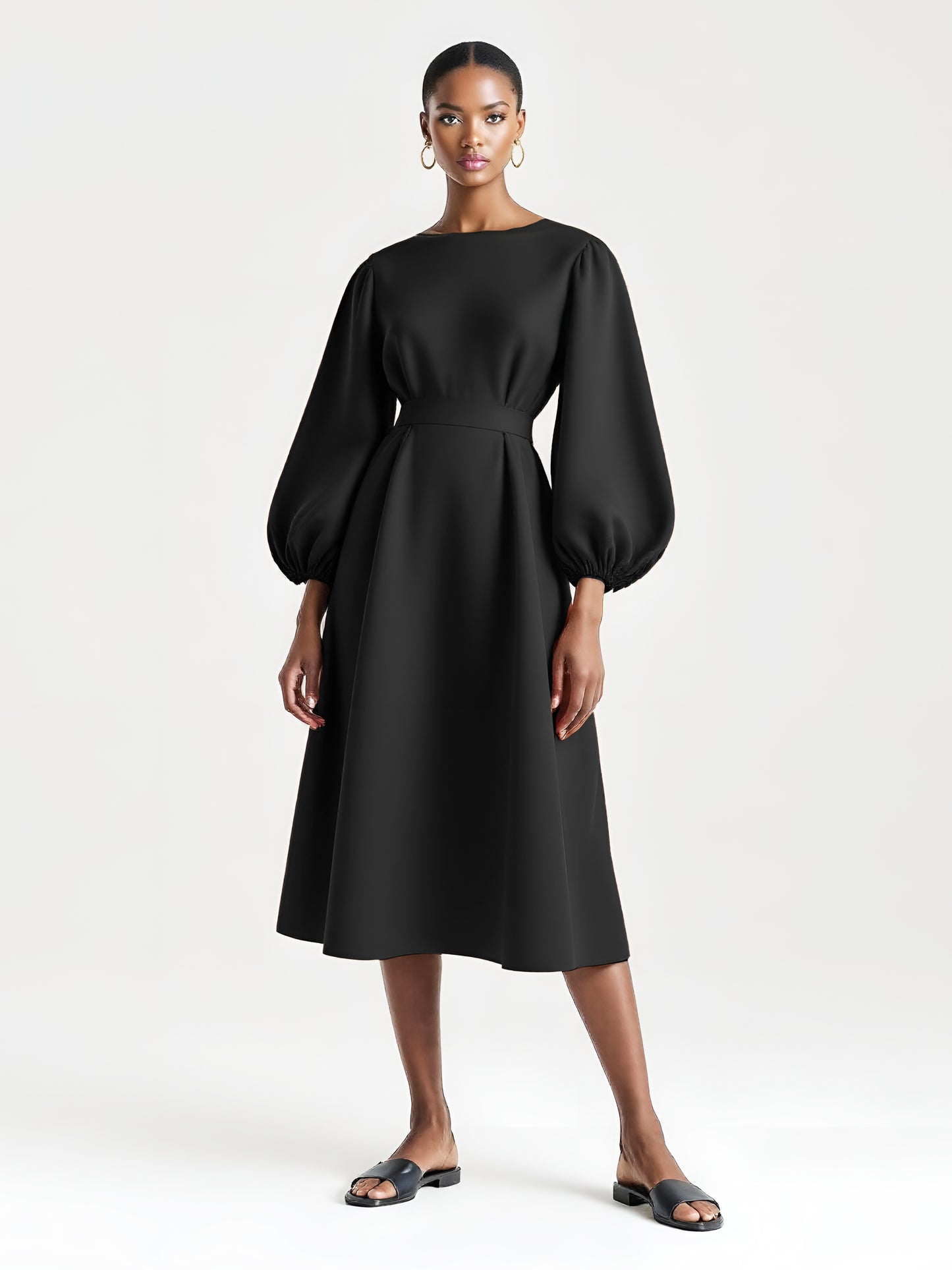 Black dress with voluminous balloon sleeves and a flared mid-calf silhouette.