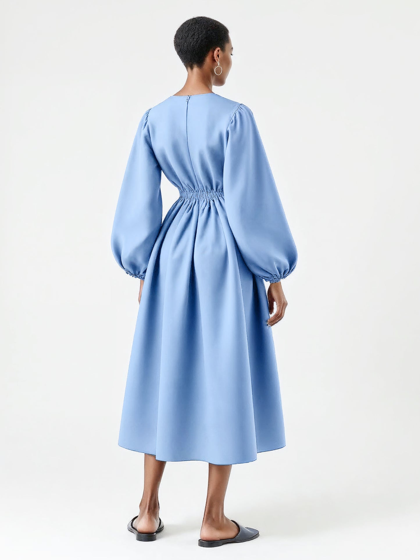 Pastel blue dress with voluminous balloon sleeves and a flared mid-calf silhouette.