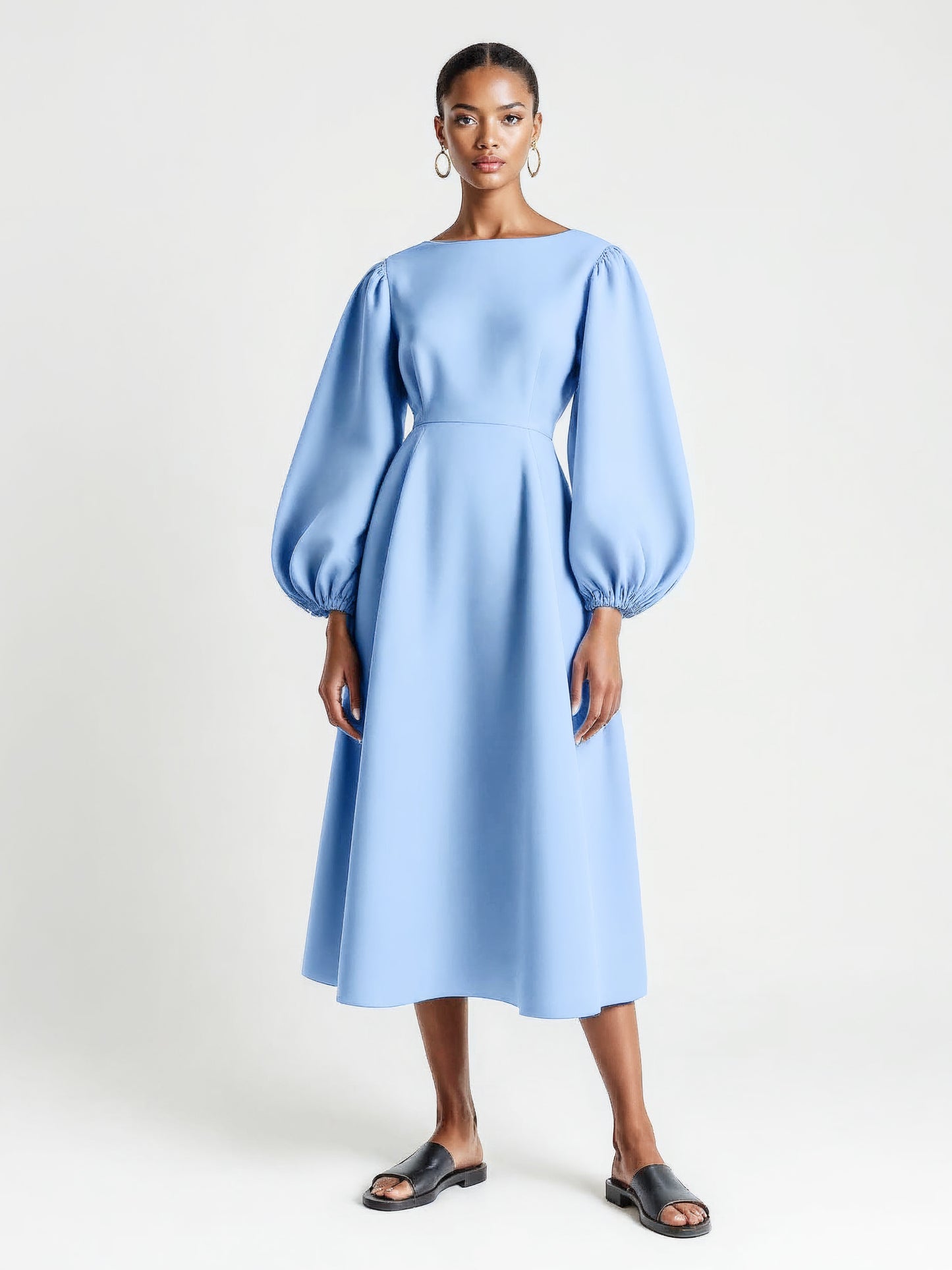 Pastel blue dress with voluminous balloon sleeves and a flared mid-calf silhouette.