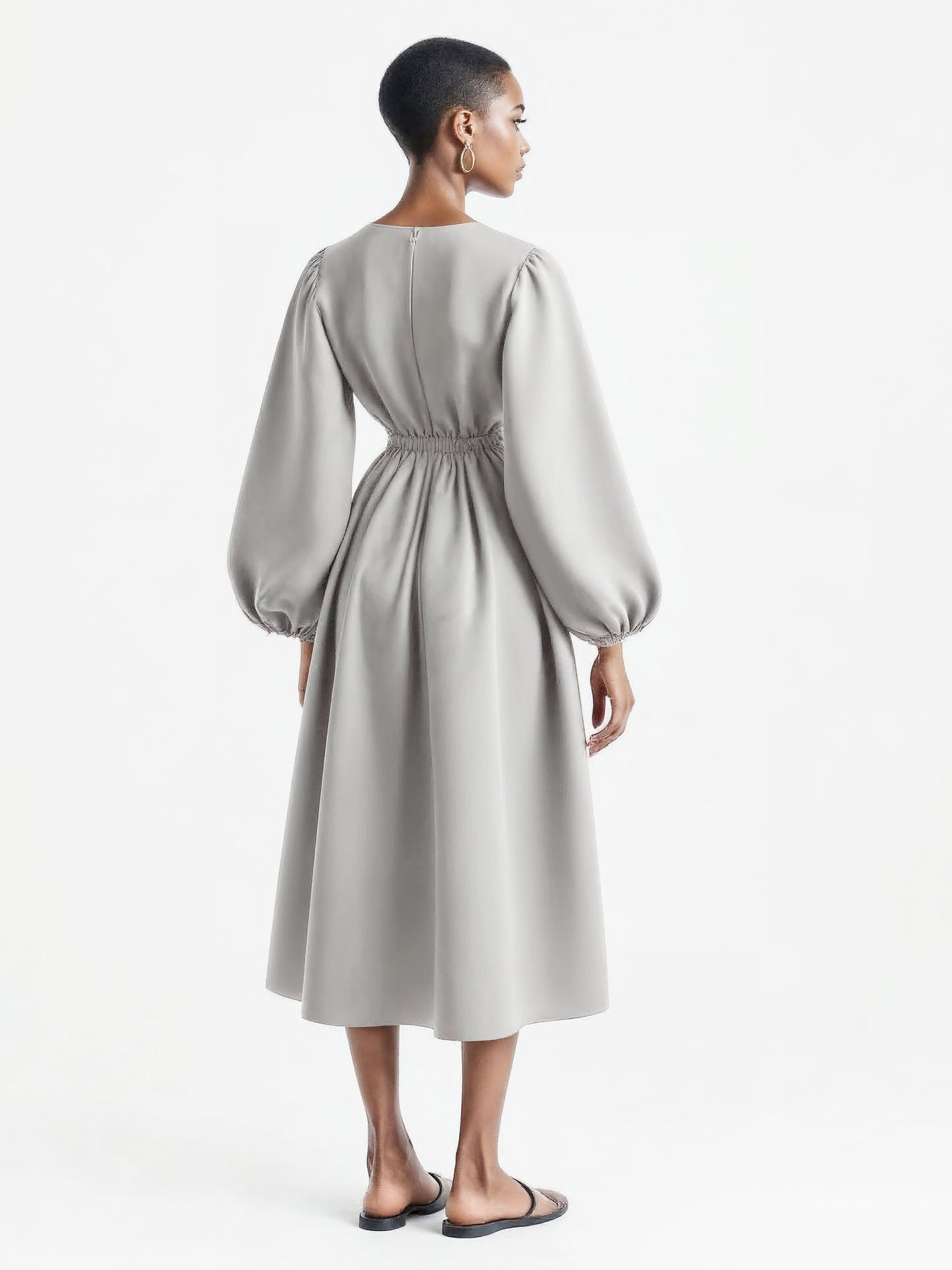 Light grey dress with voluminous balloon sleeves and a flared mid-calf silhouette.