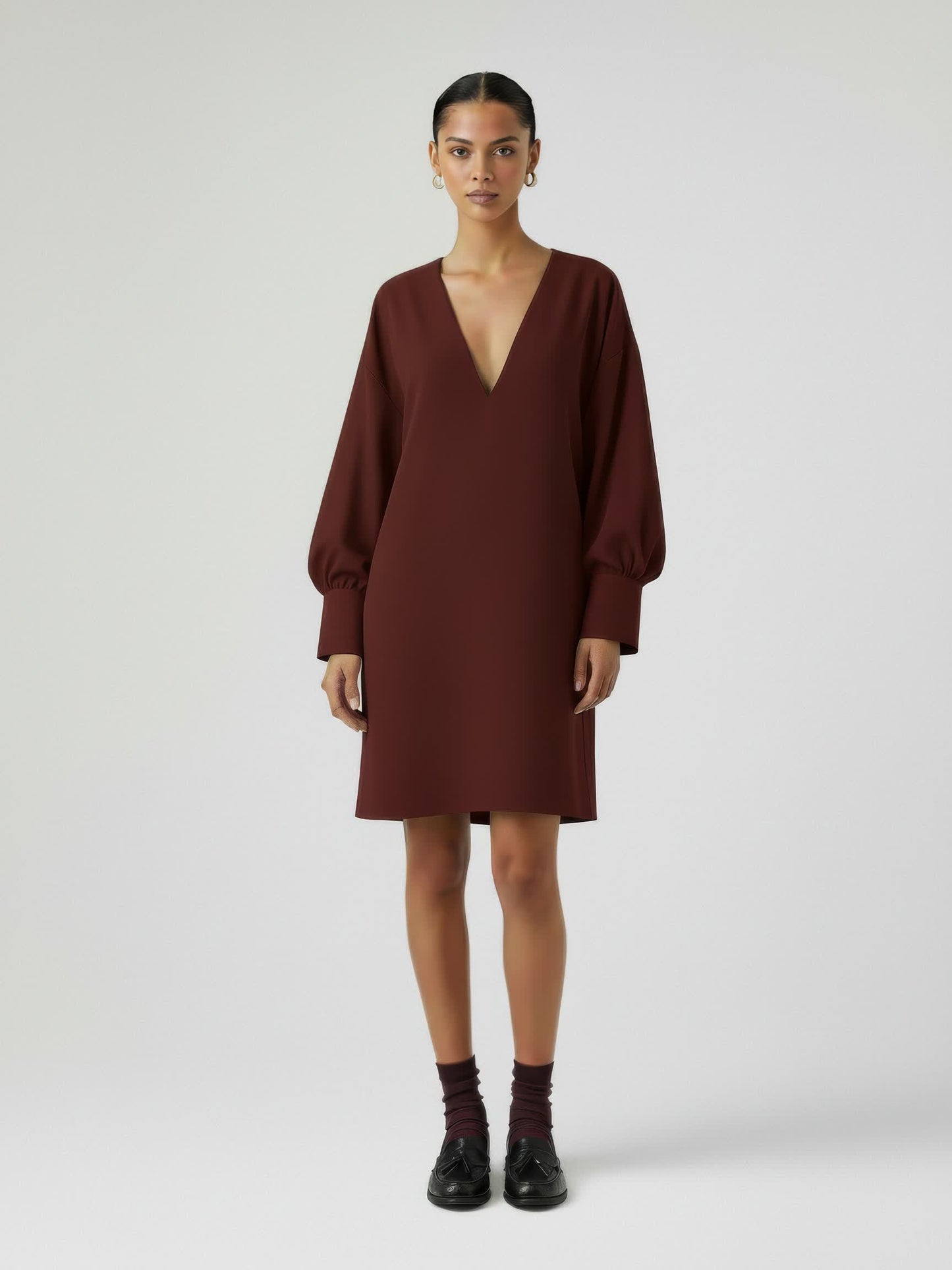 Woman wearing a brown dress on a white background