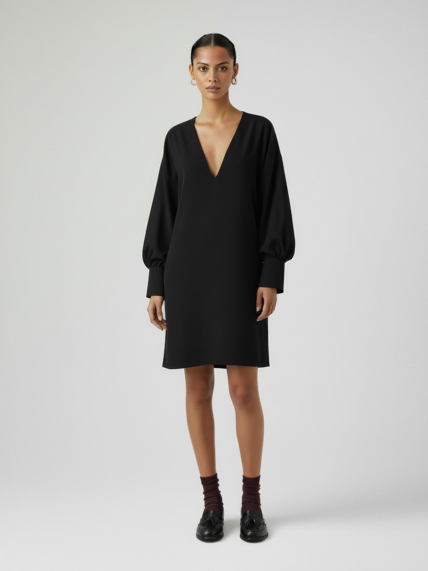 Woman wearing a black dress on a white background